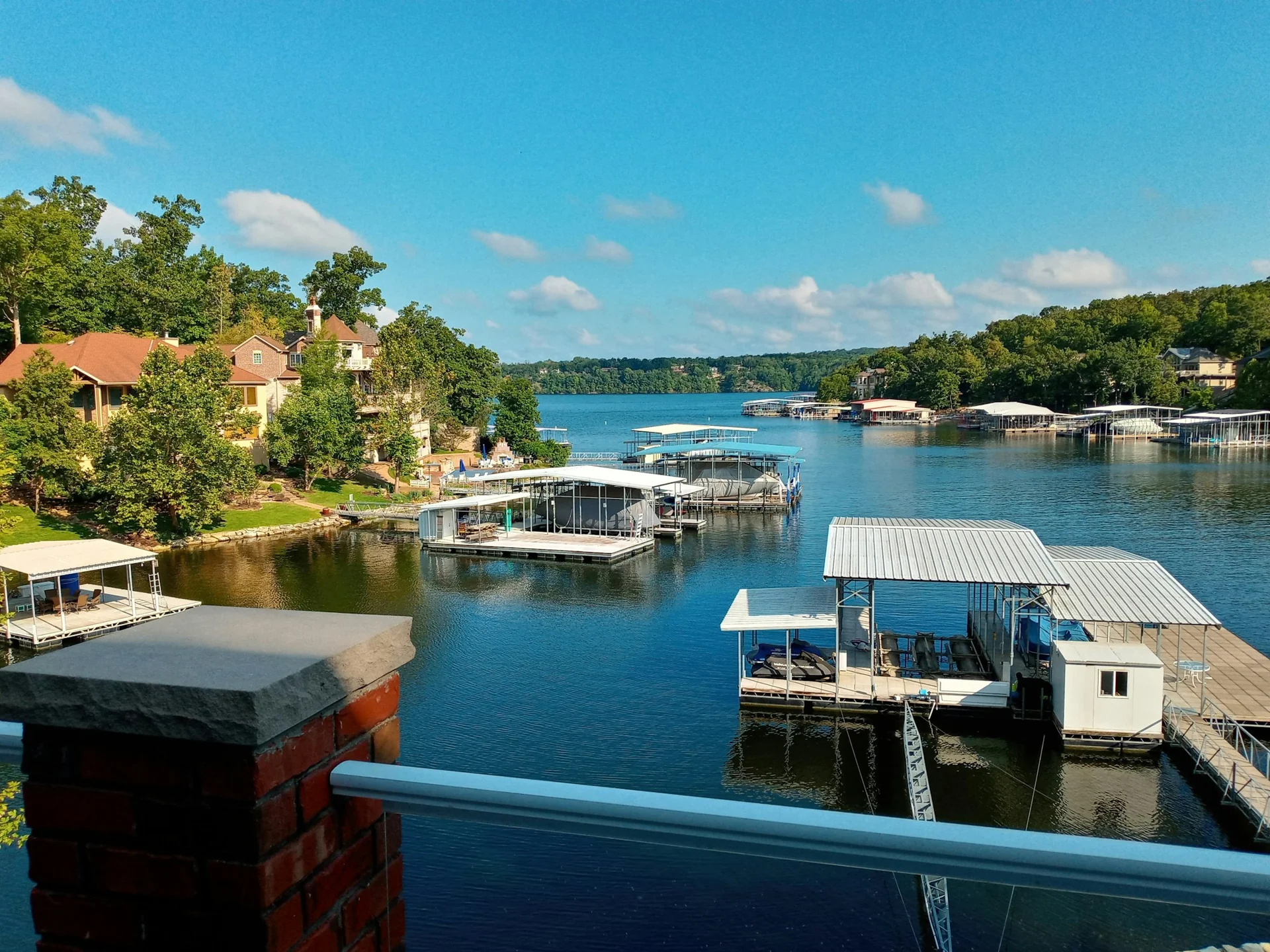 A blue-water cove with homes and covered boat docks at Lake of the Ozarks, Missouri